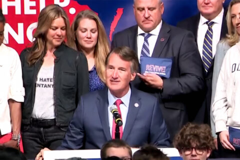 Gov. Glenn Youngkin signs executive order 26 at Stafford High School. (Photo courtesy WUSA9/YouTube)