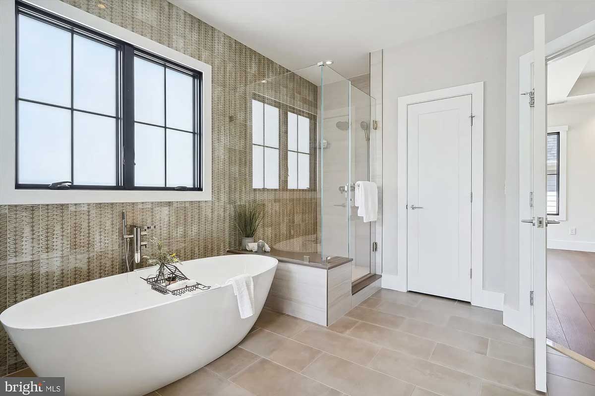 tiled bathroom with tub and walk-in shower