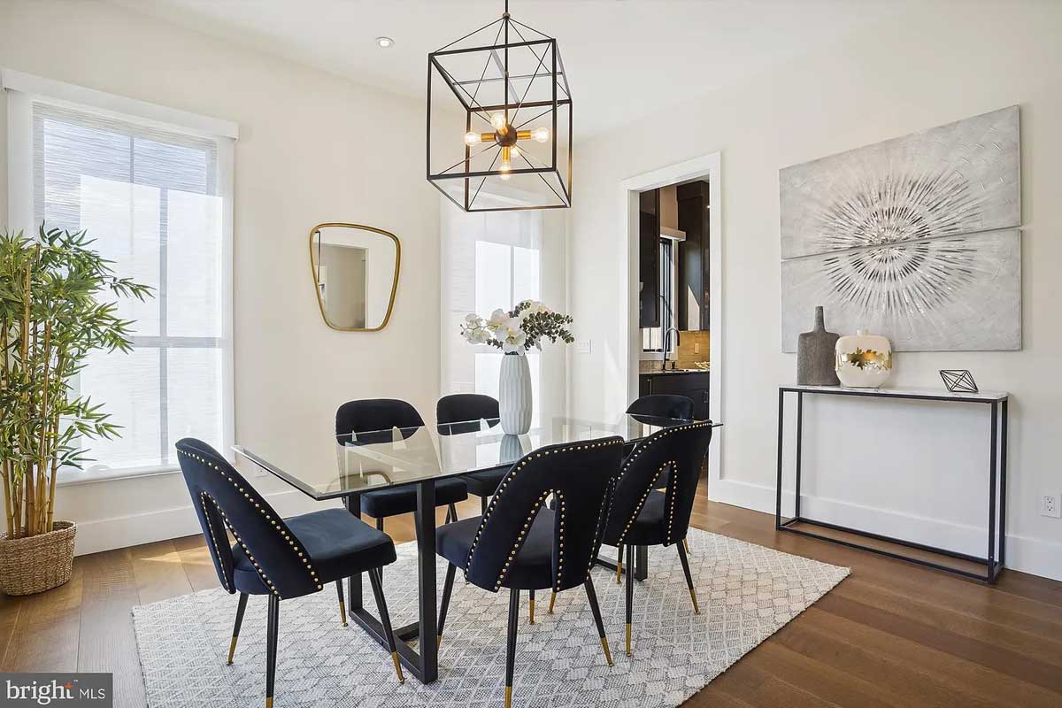 dining room with glass table and dark blue chairs