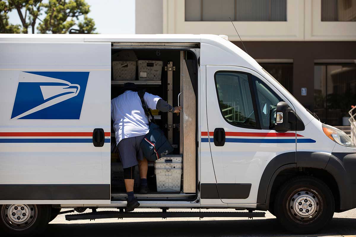 mailman getting into USPS truck