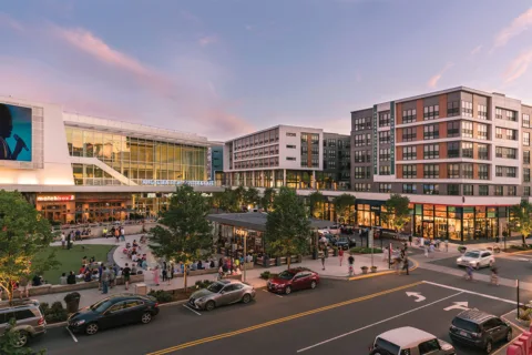 Street view of park, stores, and movie theater at the Mosaic District