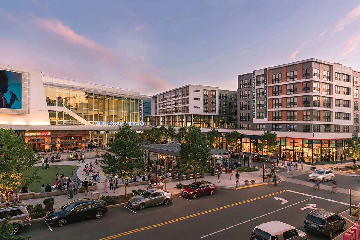 Street view of park, stores, and movie theater at the Mosaic District