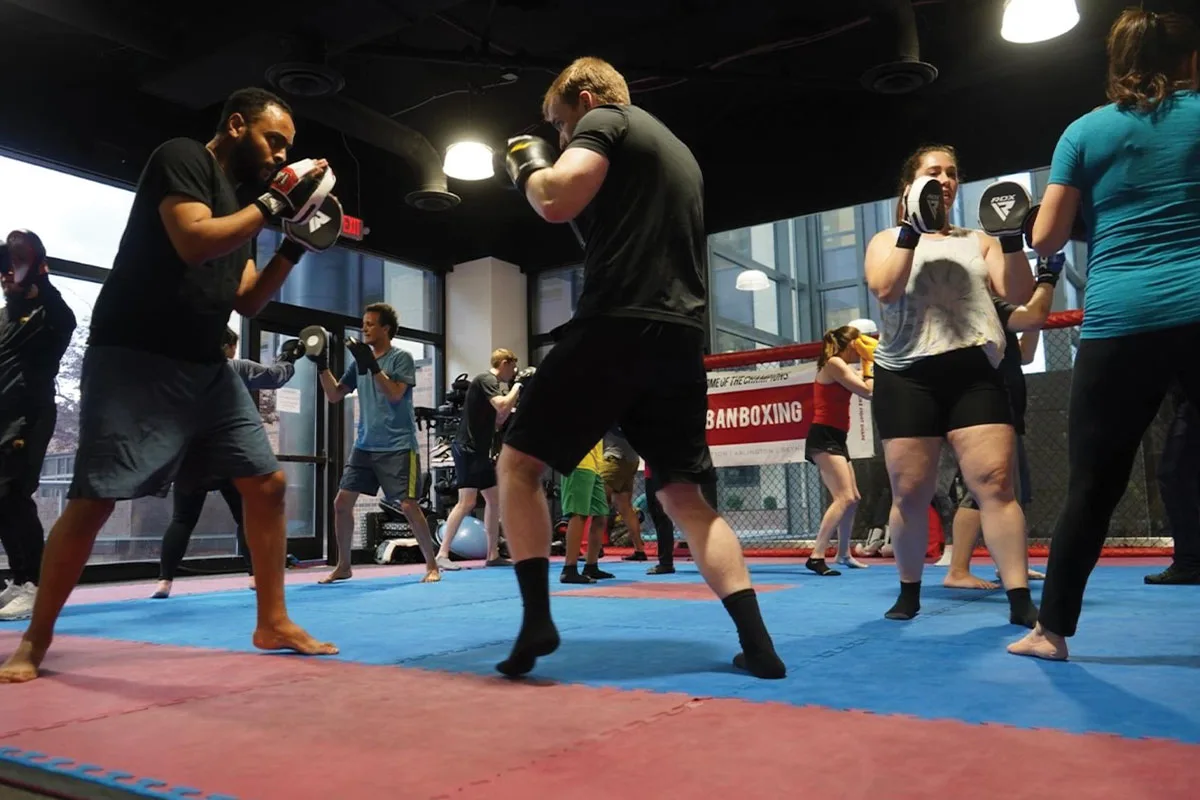People boxing in indoor boxing studio