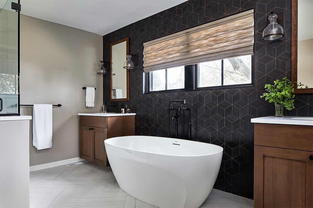 bathroom with black patterned tile wall