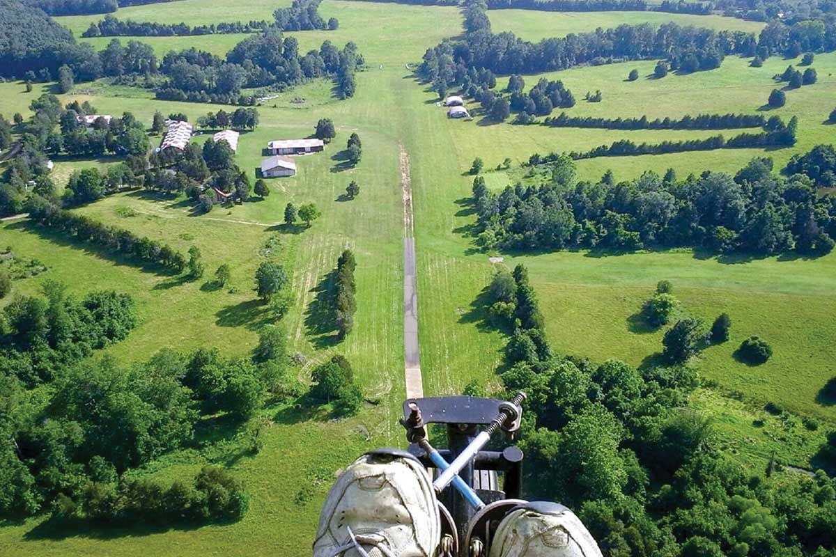 A birds-eye-view of a green hilly landscape. 