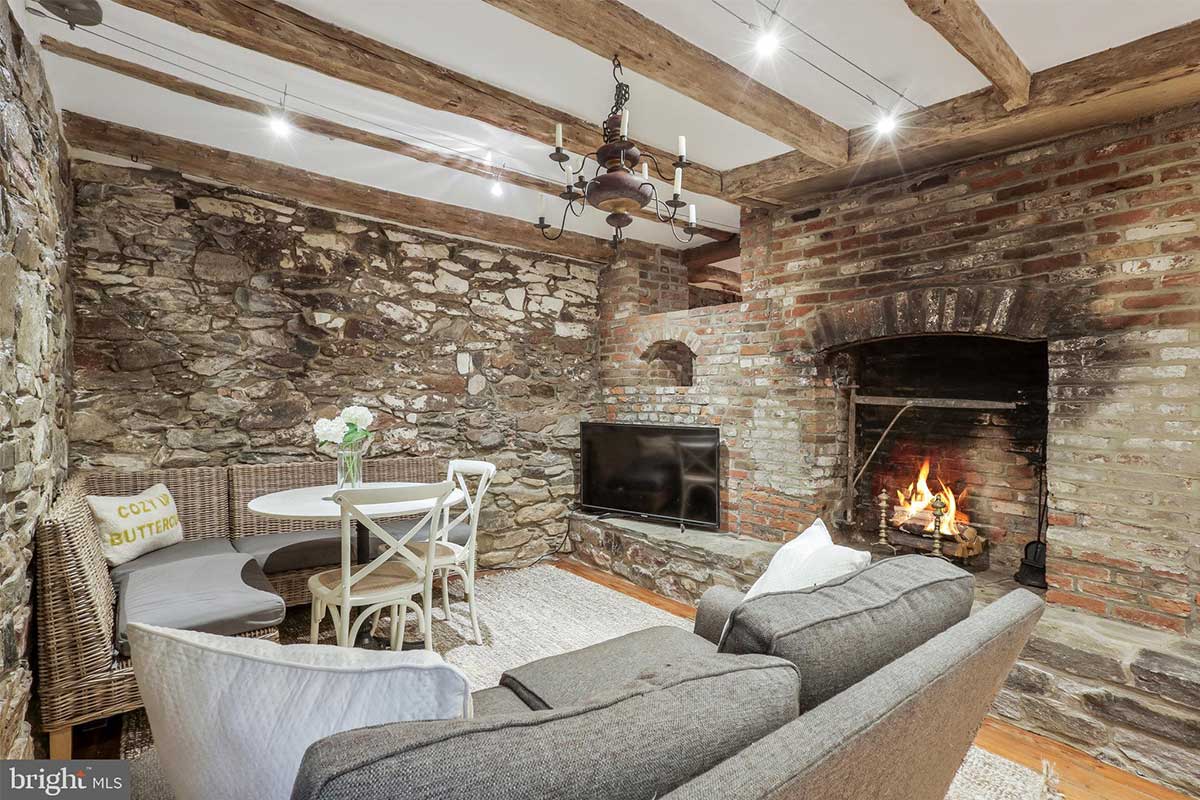 sitting area with stone walls and fireplace
