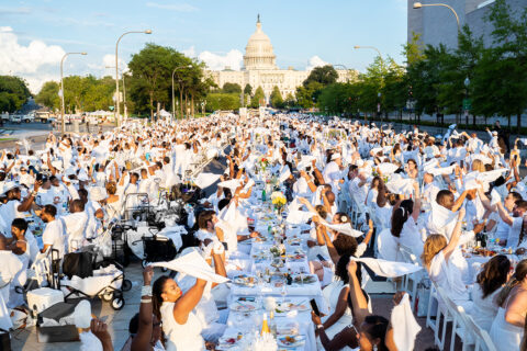 Guests at Le Diner en Blanc twirl their napkins in 2021. (Image courtesy Eric Vitale)