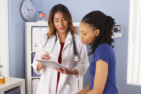 Woman speaking to female doctor