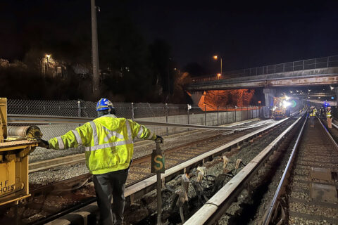 Construction worker standing on Metro rail