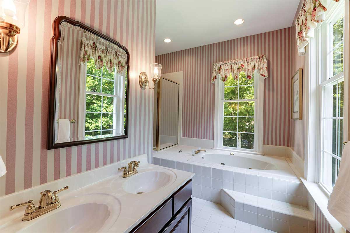 bathroom with pink and white stripped wallpaper