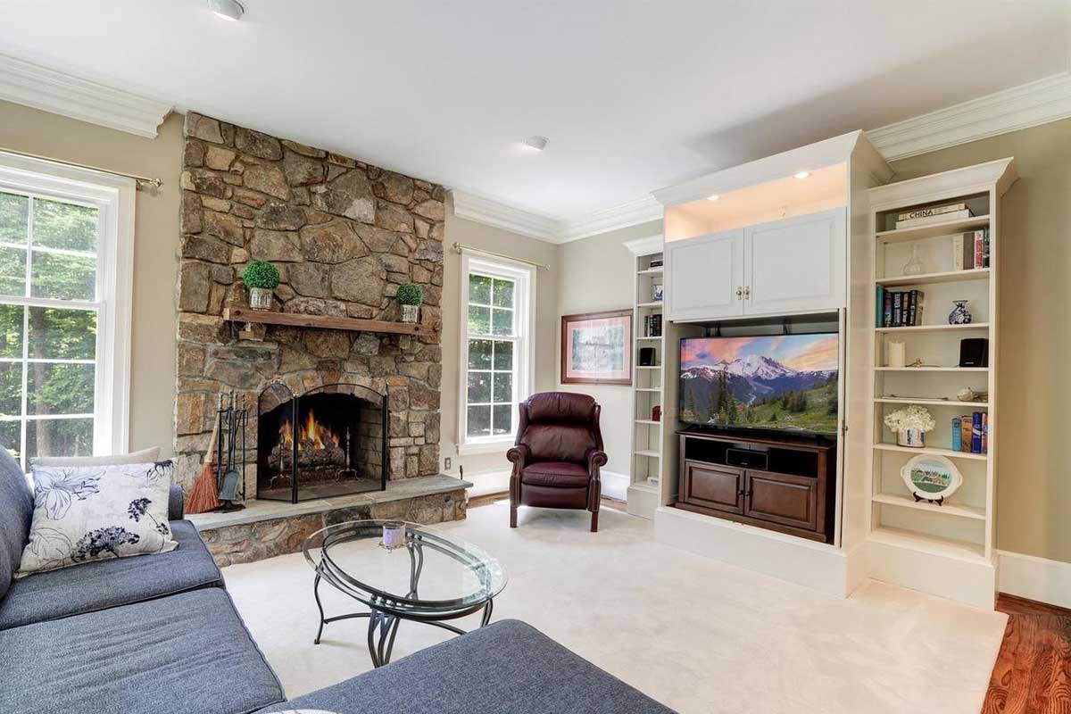 living room with stone fireplace and storage