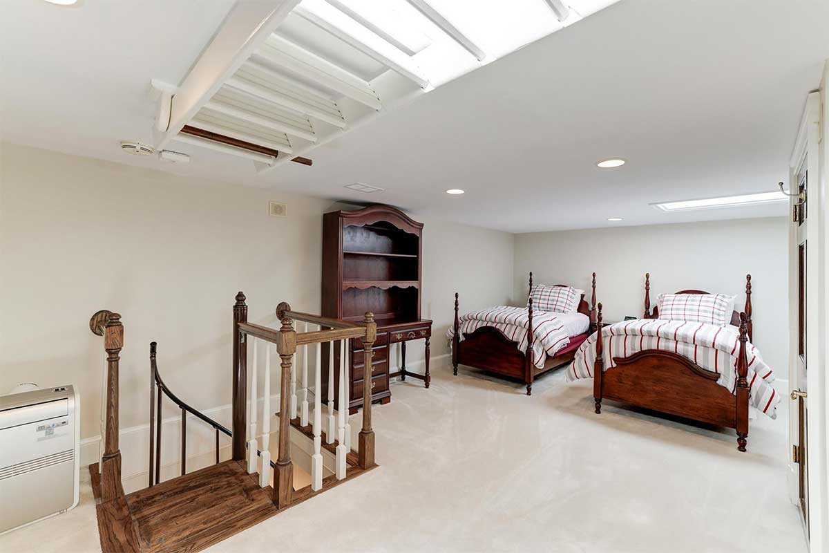 bedroom with two beds and skylight