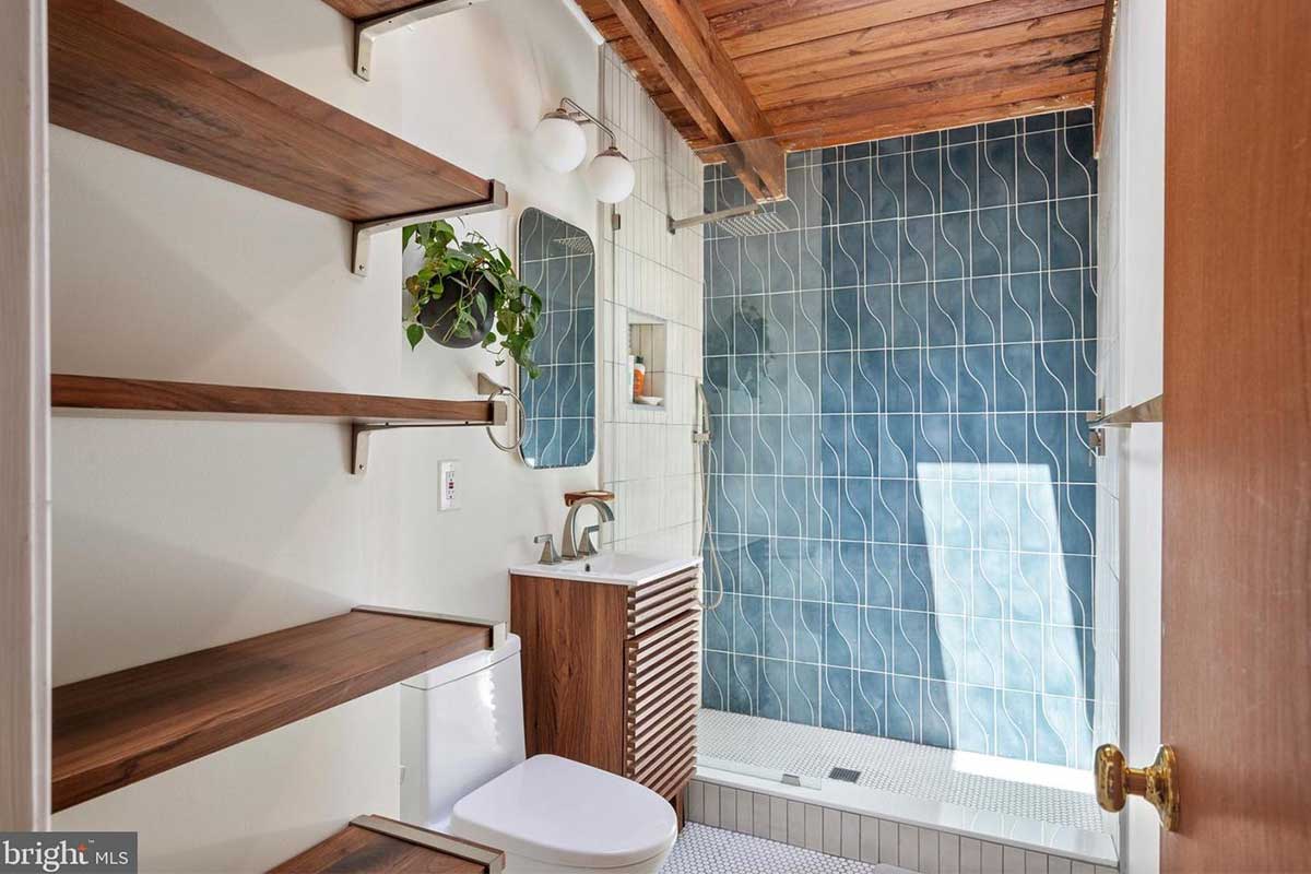 bathroom with blue tiles in walk-in shower