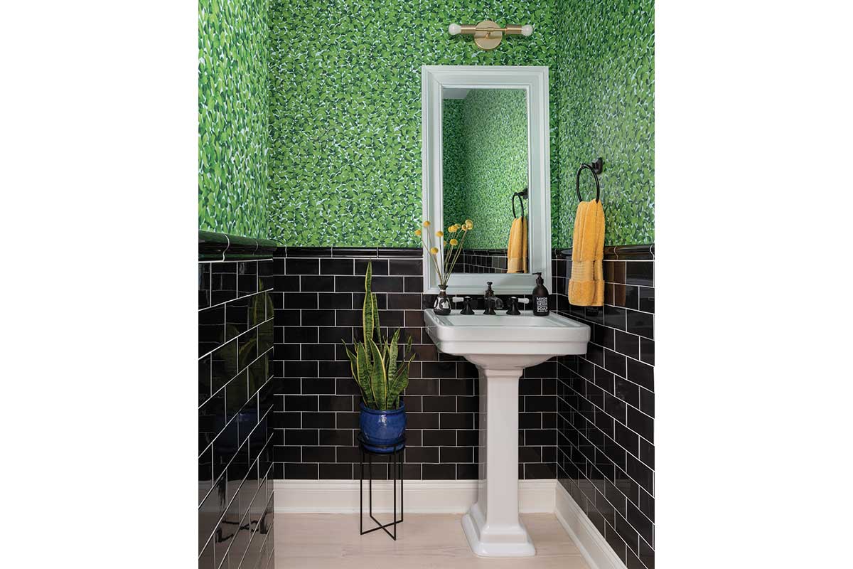 bathroom with black tile and green floral wallpaper