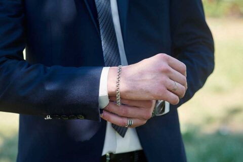 man wearing suit and bracelets, rings