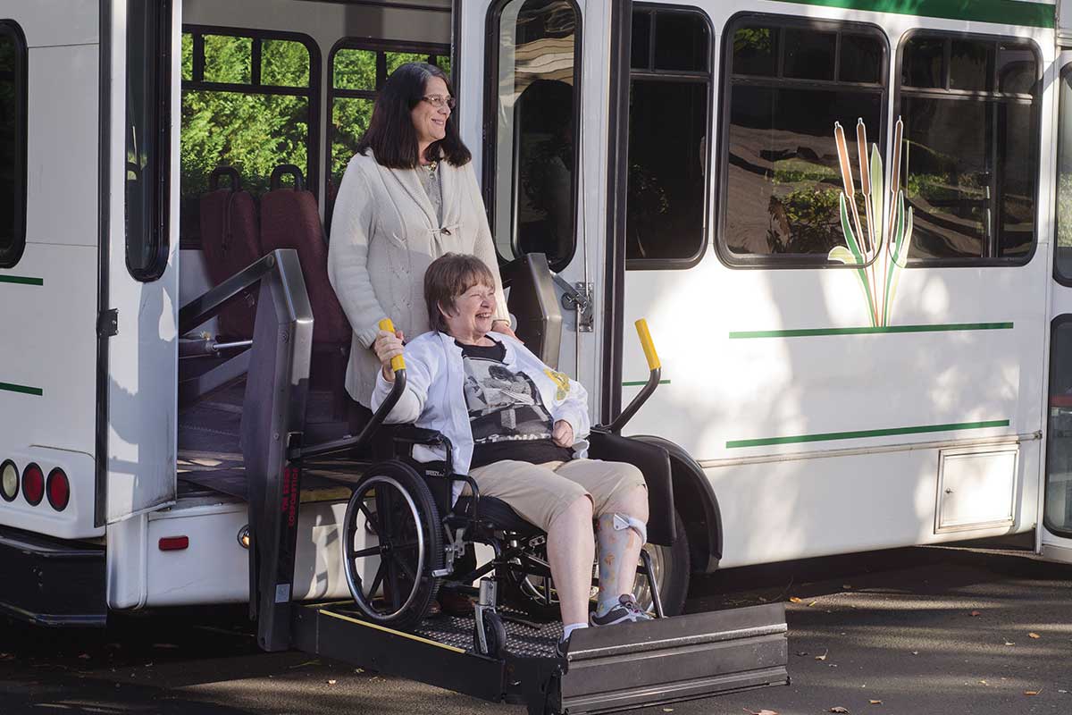 senior in wheelchair coming off accessible bus