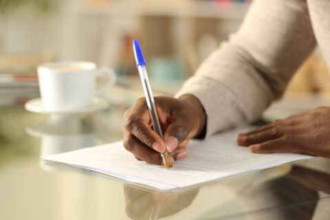 man signing document