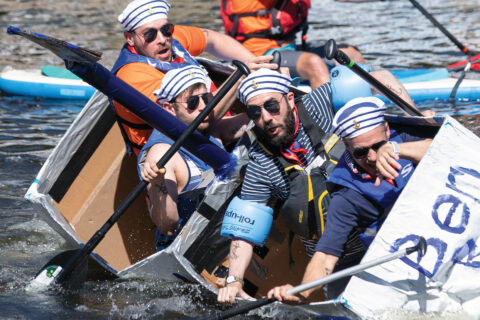 Boaters sinking on a cardboard boat at the Lake Anne Cardboard Boat Regatta