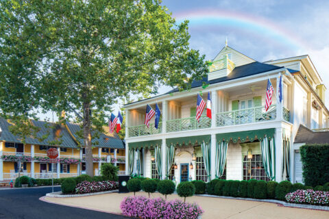 Exterior of the Inn at Little Washington with rainbow overhead