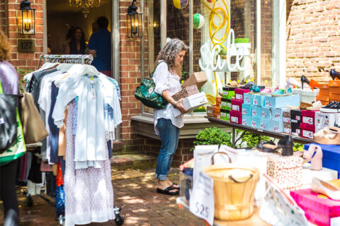 Woman shopping outside at Alexandria Sidewalk Sale