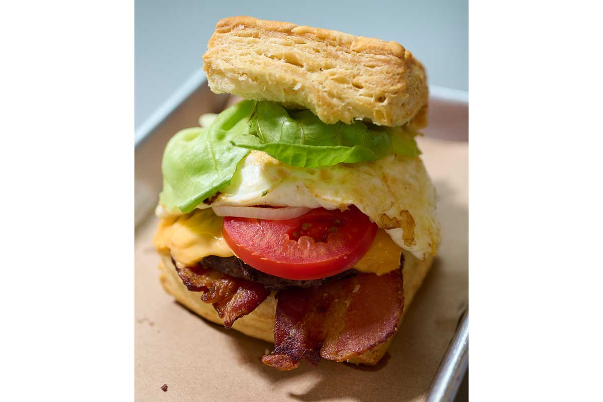 biscuit sandwich with egg, bacon, lettuce, and tomato