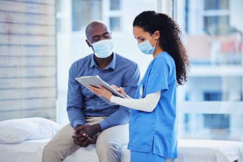 Doctor with patient both in masks