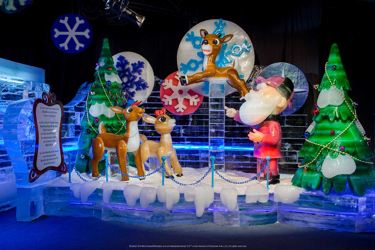 ice sculpture of rudolph flying next to santa and other reindeer