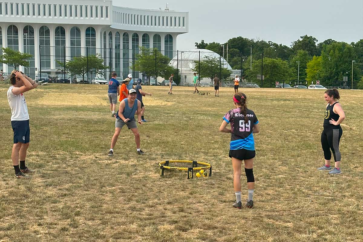 people playing spikeball in a field