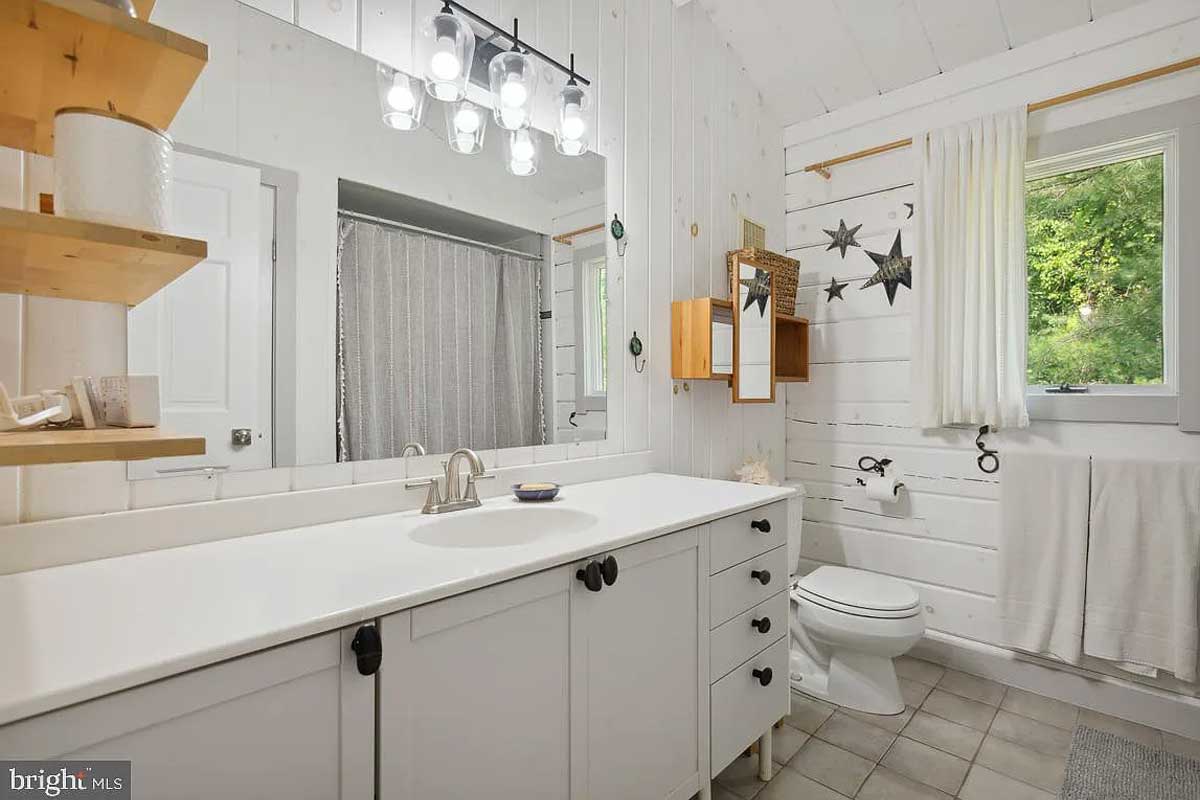 bathroom with white walls and cabinets