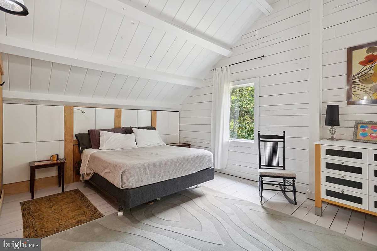 bedroom with white wood walls and ceiling