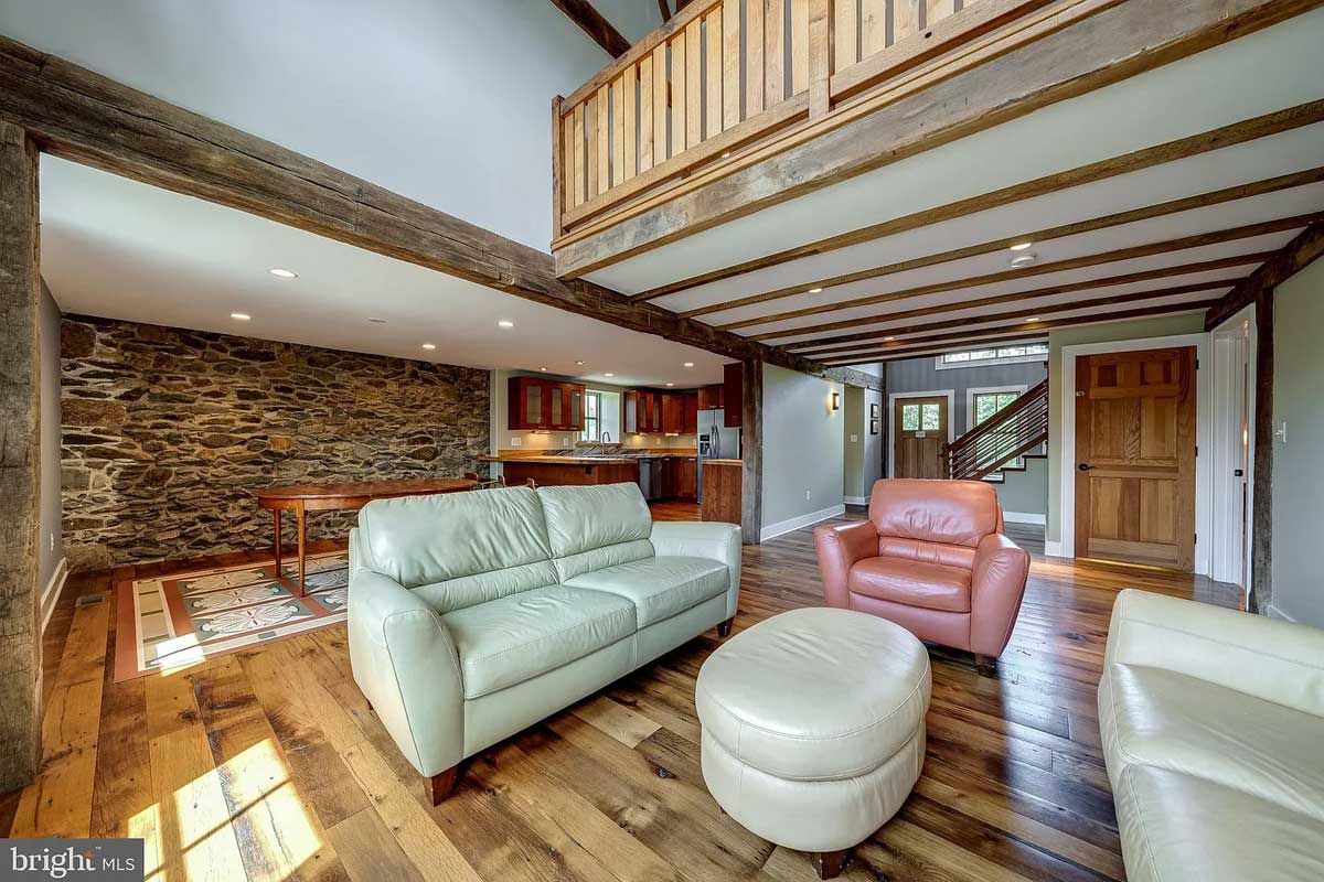 living room with wood floors and exposed wood beams