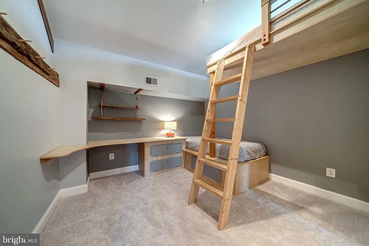 room with built-in desk and bunk bed