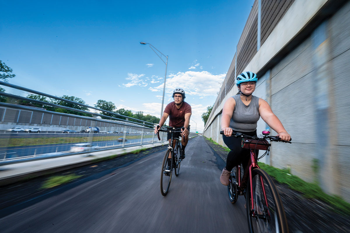 Two people riding bikes on new bike trail