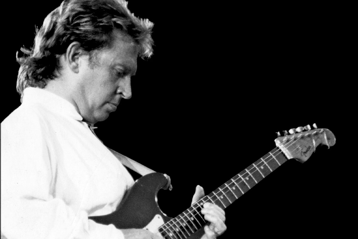 Black and white photo of Andy Summers playing guitar