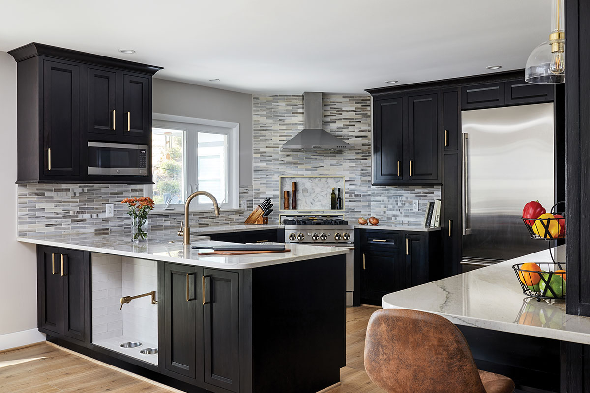 Kitchen with black cabinets, white countertops, and gray backsplash.