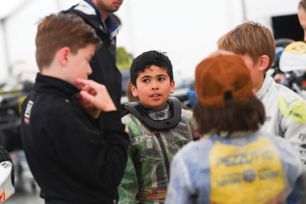 Lucas Palacio talks with other young go-karters