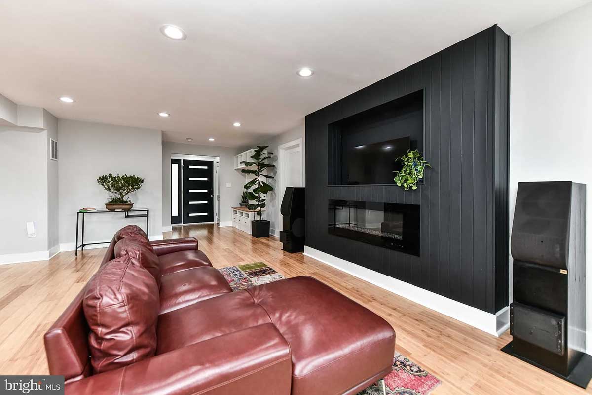 living room with black fireplace and leather couch