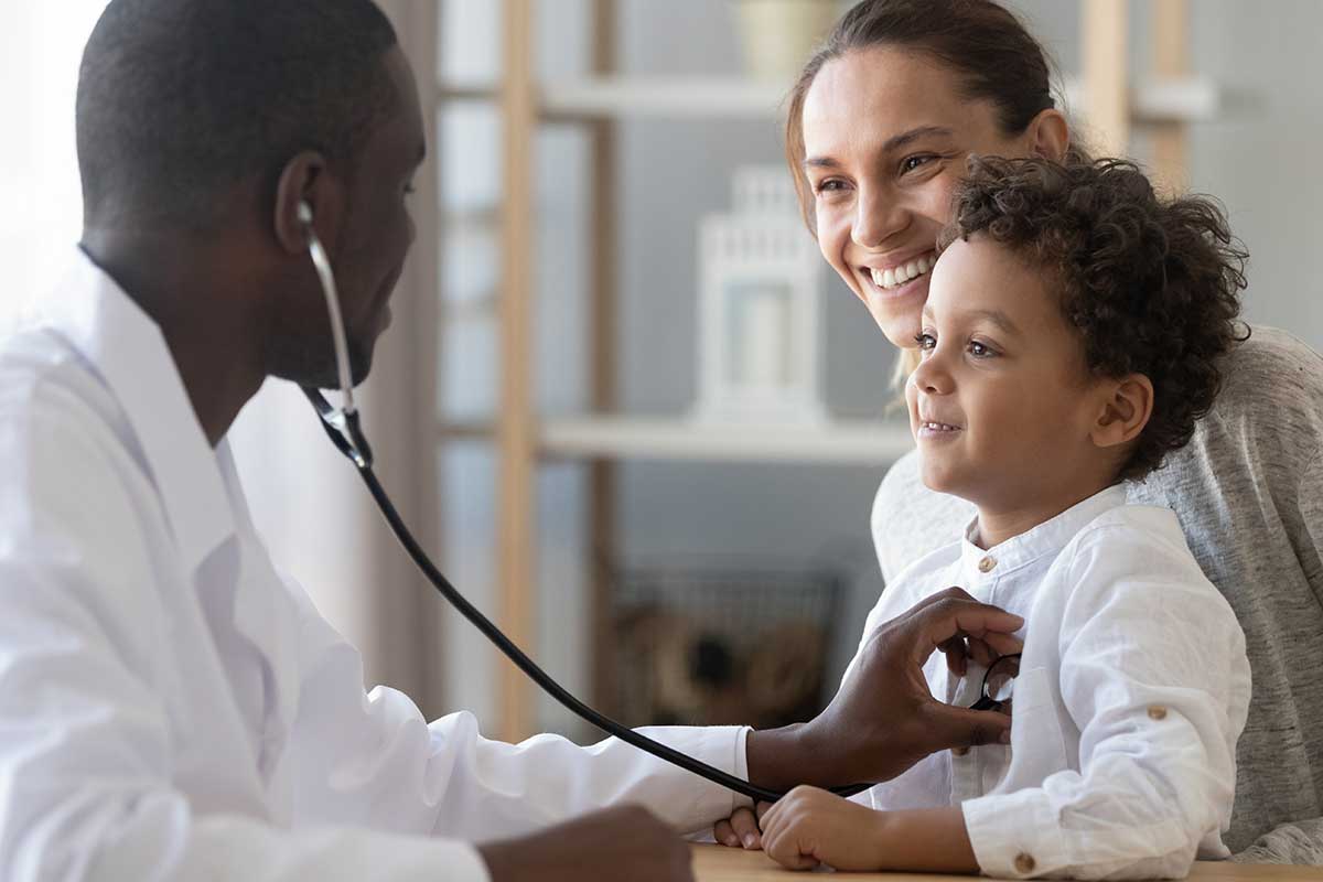 doctor checking child patient with parent