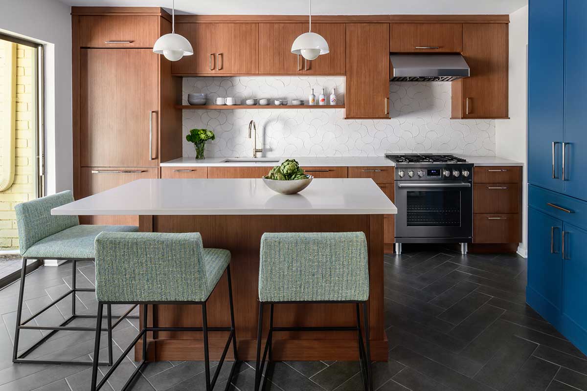 remodeled kitchen with walnut cabinets and white backsplash