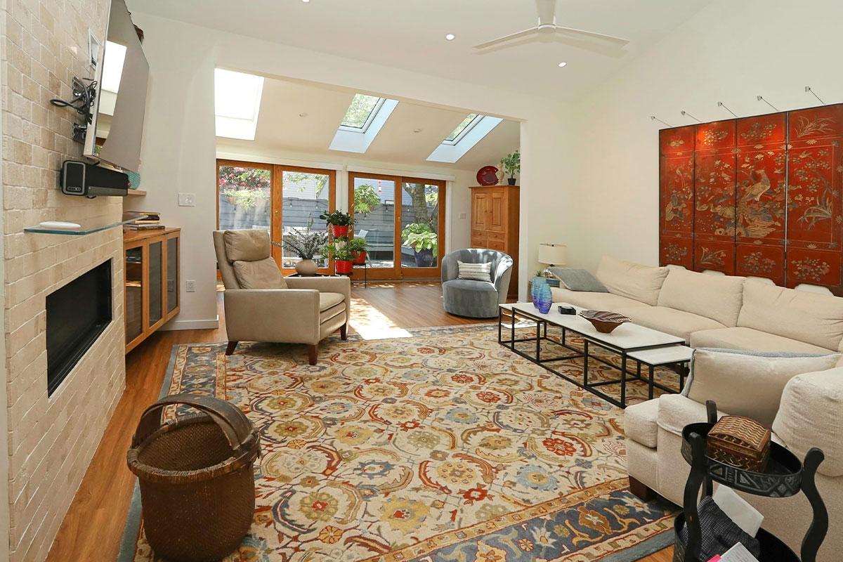 Living room with large rug and ornate art over couch