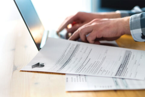 Financial paperwork next to computer