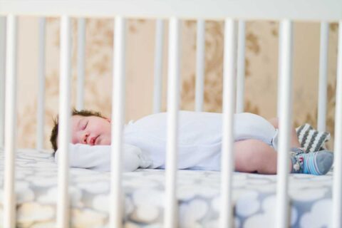 infant sleeping in crib
