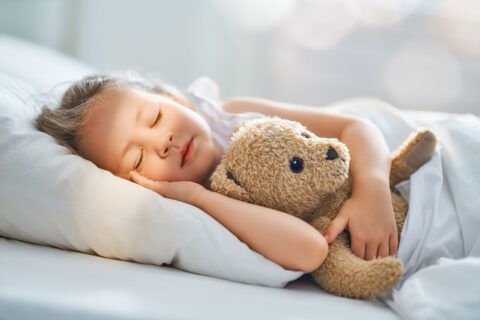 girl sleeping with teddy bear