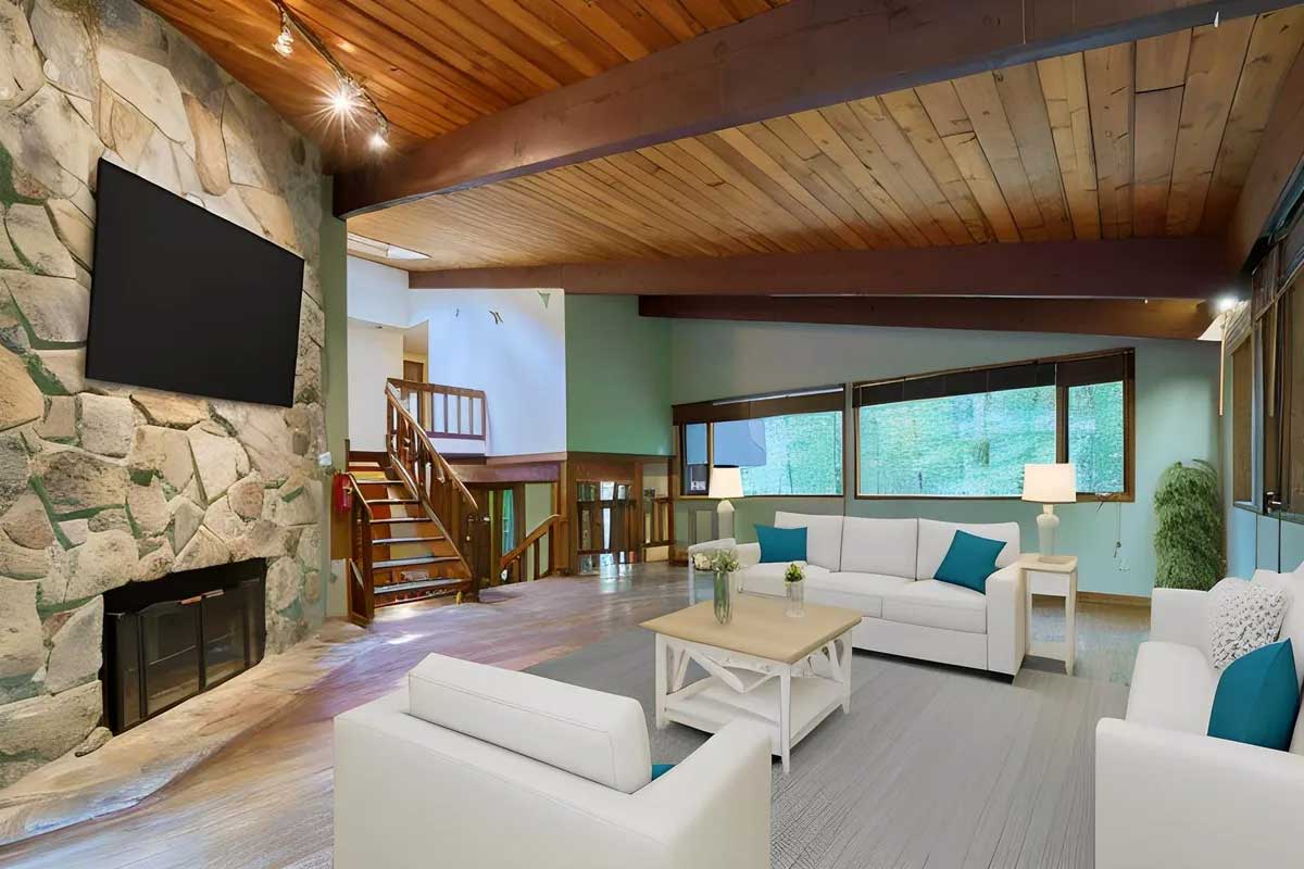 family room with stone fireplace and wood ceilings