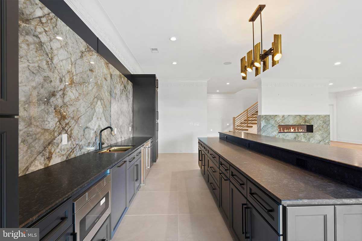custom wet bar with dark cabinets and island