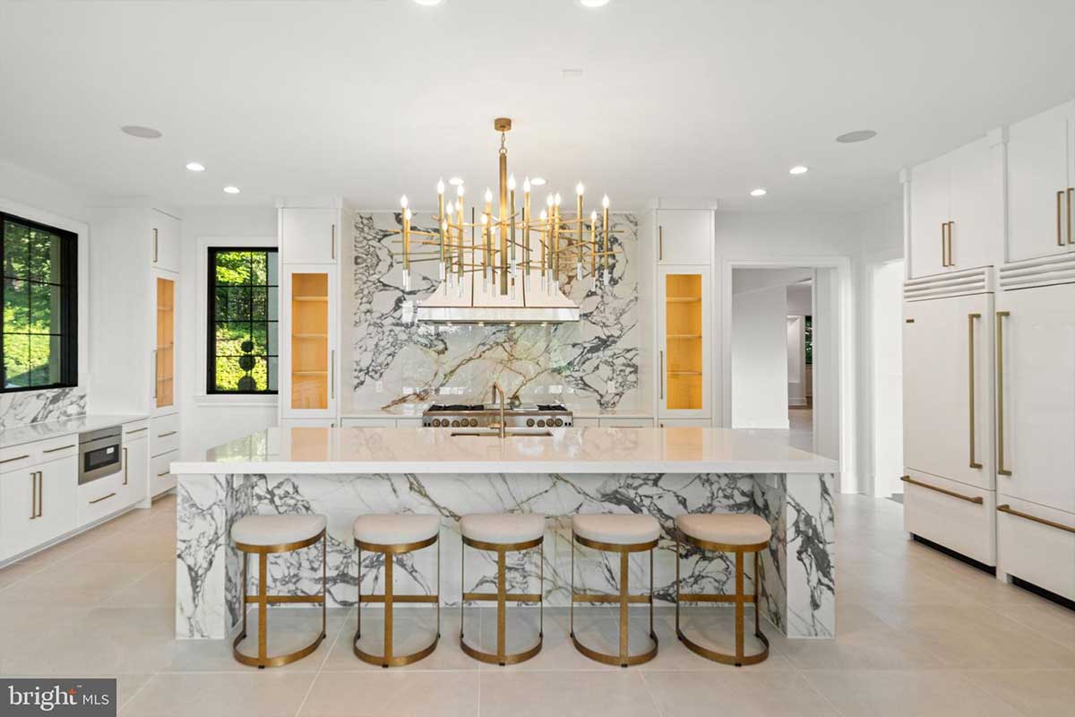 white kitchen with italian porcelain accents on wall and island