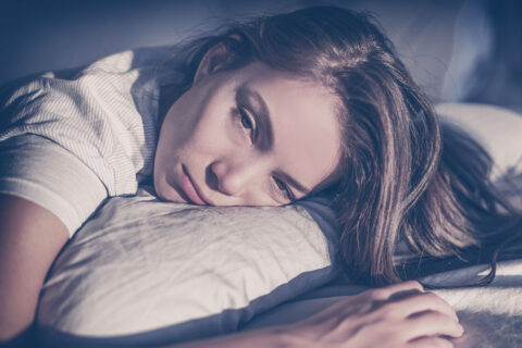woman depressed on bed