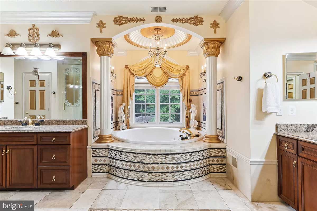 mosaic bathtub with gold accents and columns