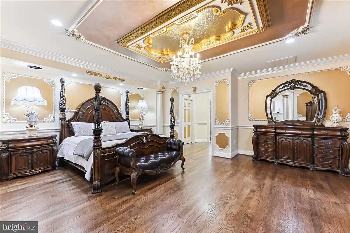 bedroom with chandelier accent and hardwood floors