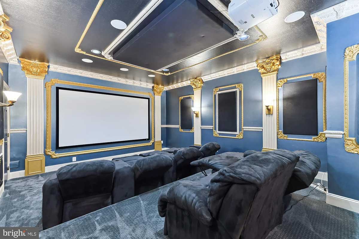 home theater with blue walls and recliners